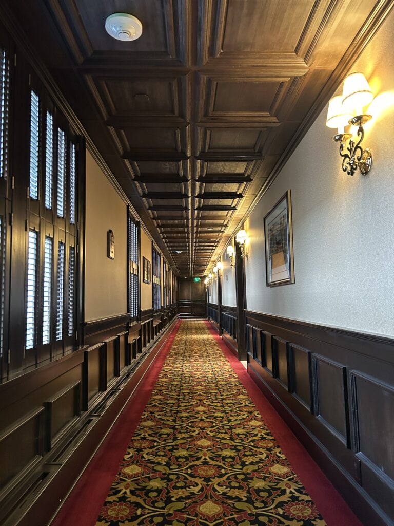 The American Club Hotel hallway with traditional carpet