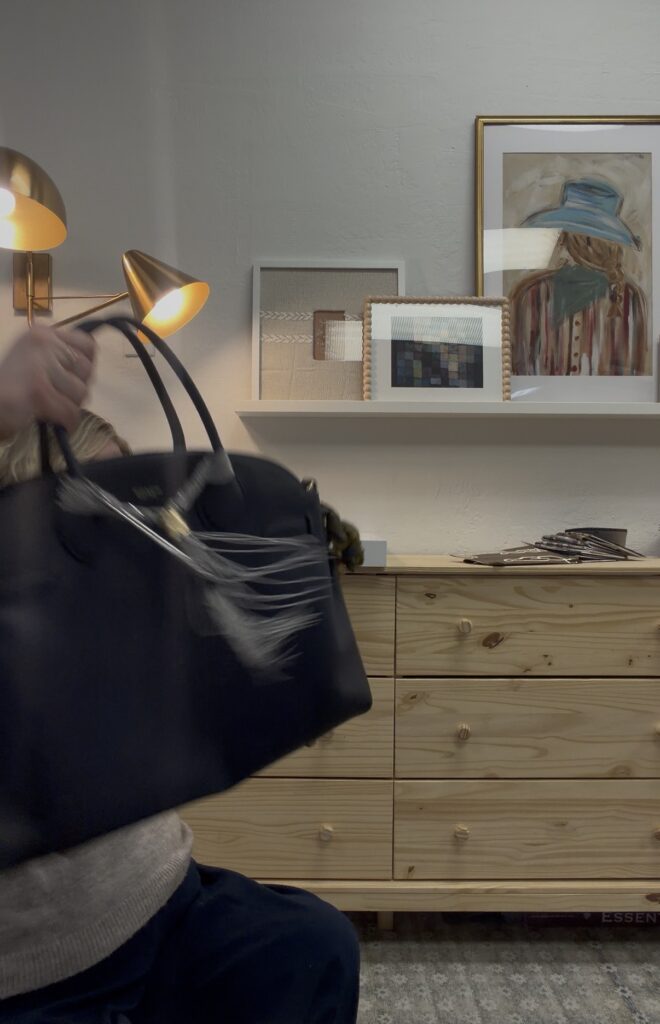 Accessible office styling behind the scenes for Instagram, featuring a wood dresser, layered lighting, framed artwork, and everyday design details in a lived in space.